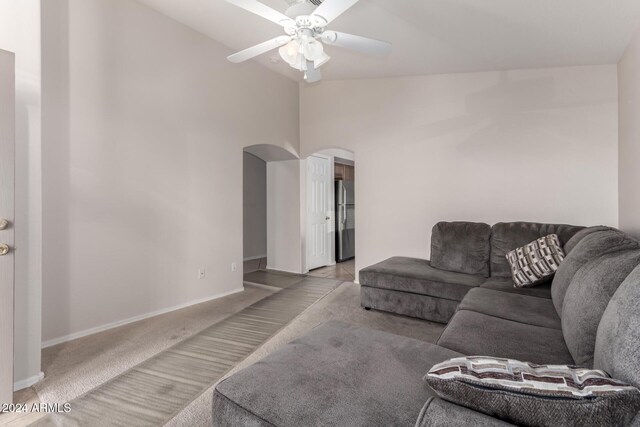 living room featuring light carpet, ceiling fan, and high vaulted ceiling