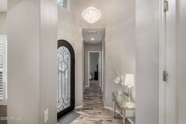 4519 N 29th Way, Phoenix, AZ 85016 - entrance foyer with wood finished floors, a chandelier, a high ceiling, and baseboards