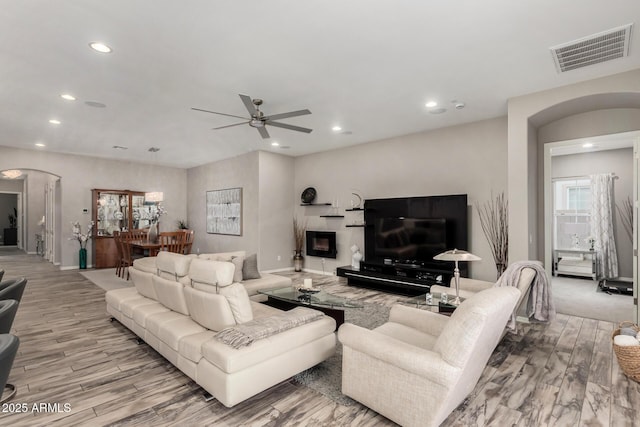 4519 N 29th Way, Phoenix, AZ 85016 - living area with arched walkways, recessed lighting, ceiling fan, wood finished floors, and baseboards