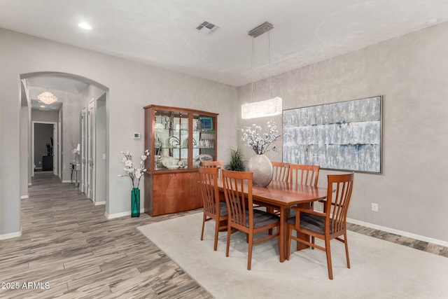 4519 N 29th Way, Phoenix, AZ 85016 - dining space featuring arched walkways, wood finished floors, baseboards, and recessed lighting