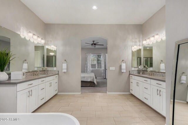 4519 N 29th Way, Phoenix, AZ 85016 - ensuite bathroom featuring two vanities, ceiling fan, baseboards, and a freestanding bath