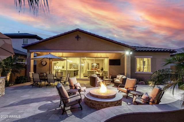 4519 N 29th Way, Phoenix, AZ 85016 - back of property with stucco siding, a patio area, outdoor dining area, a tiled roof, and an outdoor living space with a fire pit