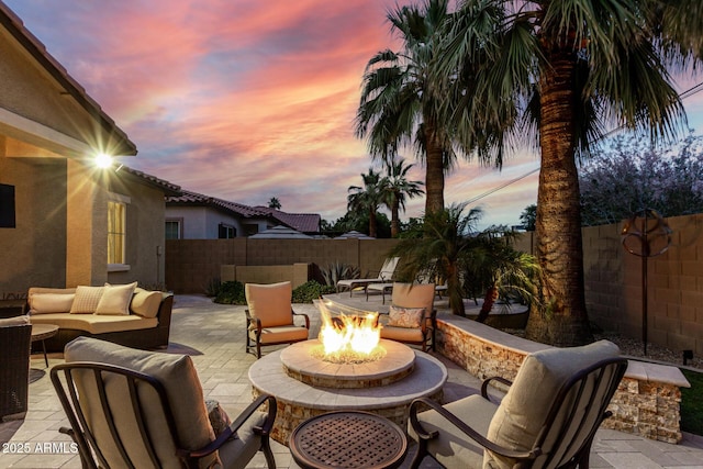 4519 N 29th Way, Phoenix, AZ 85016 - patio terrace at dusk with an outdoor living space with a fire pit, a patio, and a fenced backyard