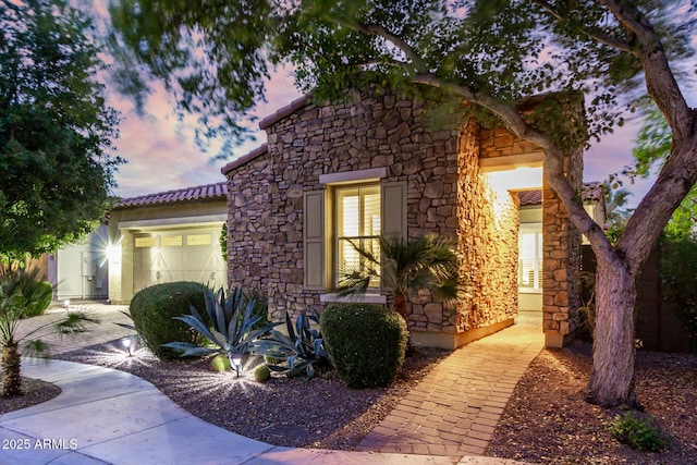 4519 N 29th Way, Phoenix, AZ 85016 - view of front of house featuring stone siding, a garage, and a tile roof