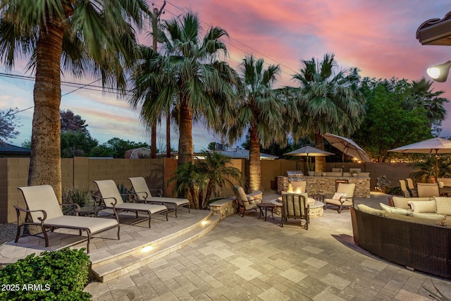 4519 N 29th Way, Phoenix, AZ 85016 - patio terrace at dusk featuring an outdoor living space, a patio, and a fenced backyard