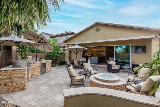 4519 N 29th Way, Phoenix, AZ 85016 - view of patio / terrace featuring an outdoor living space with a fire pit and outdoor dining space