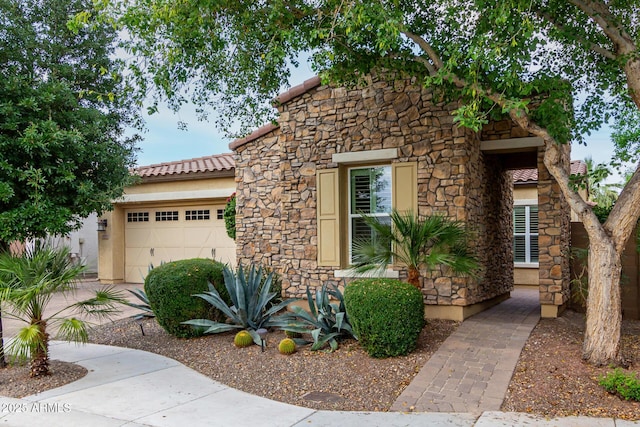 4519 N 29th Way, Phoenix, AZ 85016 - view of front of home featuring stone siding, an attached garage, a tiled roof, and stucco siding