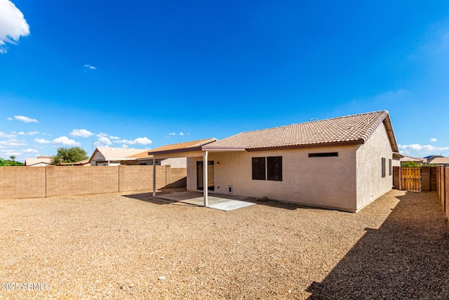 9332 W Mary Ann Dr, Peoria, AZ 85382 - rear view of house featuring a tiled roof, stucco siding, a patio, and a fenced backyard