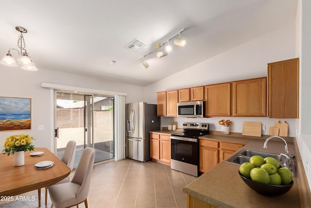 9332 W Mary Ann Dr, Peoria, AZ 85382 - kitchen with appliances with stainless steel finishes, lofted ceiling, a sink, light tile patterned floors, and track lighting