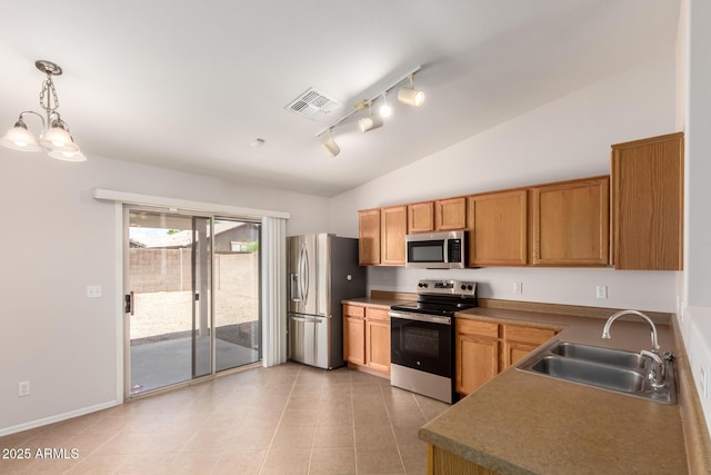 9332 W Mary Ann Dr, Peoria, AZ 85382 - kitchen featuring stainless steel appliances, a sink, light tile patterned floors, lofted ceiling, and rail lighting