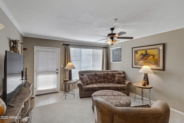 carpeted living room with ceiling fan, ornamental molding, and a textured ceiling