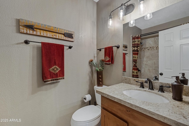 bathroom with vanity, walk in shower, and toilet