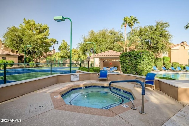 view of pool with a community hot tub and tennis court