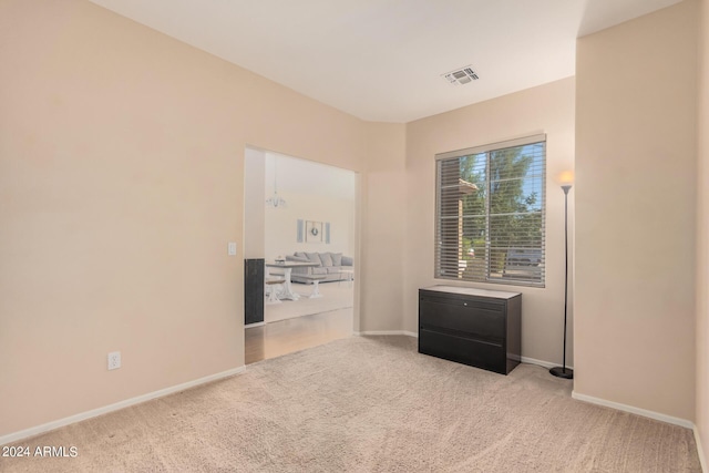 carpeted empty room with baseboards and visible vents