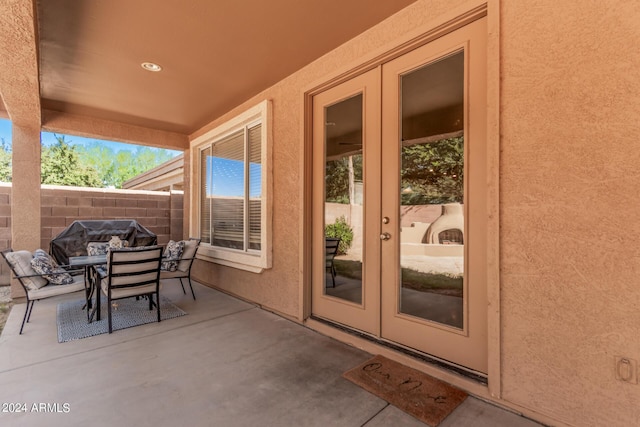 view of patio / terrace featuring outdoor dining space, french doors, and fence