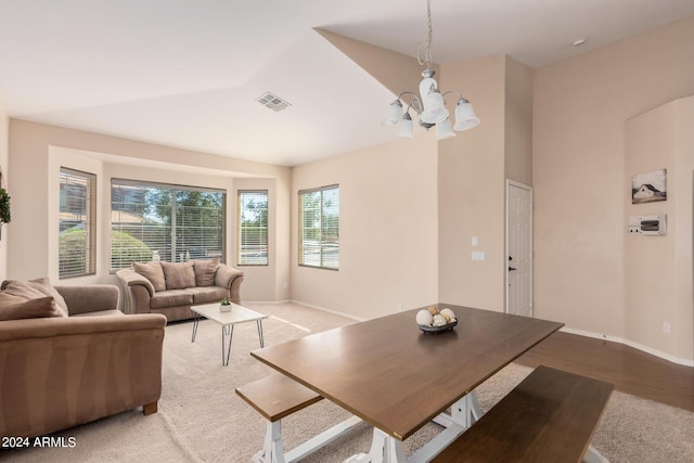 living area with baseboards, visible vents, and an inviting chandelier