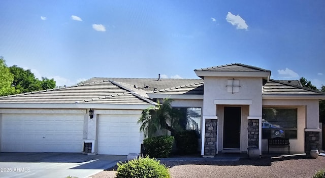 4429 E Downing Cir, Mesa, AZ 85205 - view of front of home with driveway, an attached garage, a tile roof, and stone siding