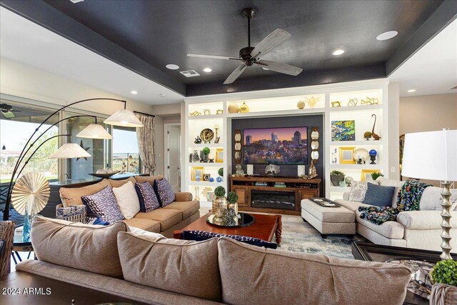 living room with wood-type flooring and ceiling fan