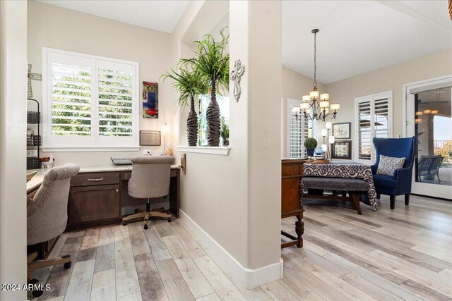 office featuring light wood-type flooring and a notable chandelier