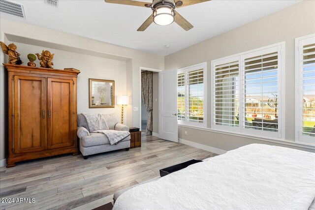 bedroom with light hardwood / wood-style flooring and ceiling fan