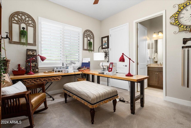 carpeted office space featuring ceiling fan