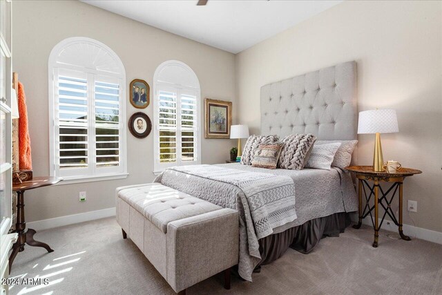 bedroom with light carpet and ceiling fan