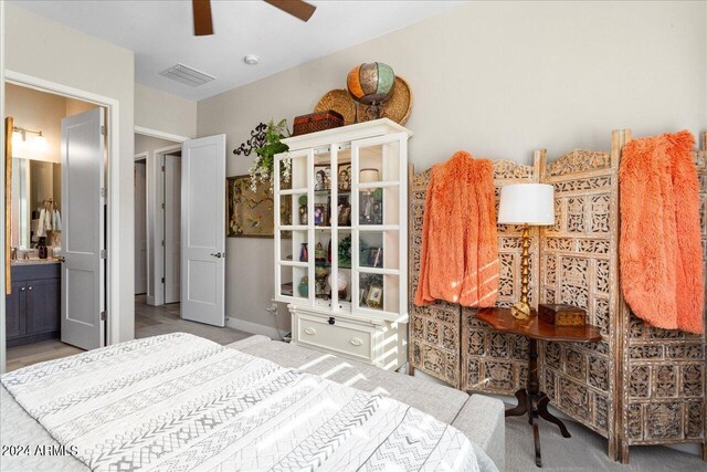 bedroom featuring ensuite bath, ceiling fan, and sink