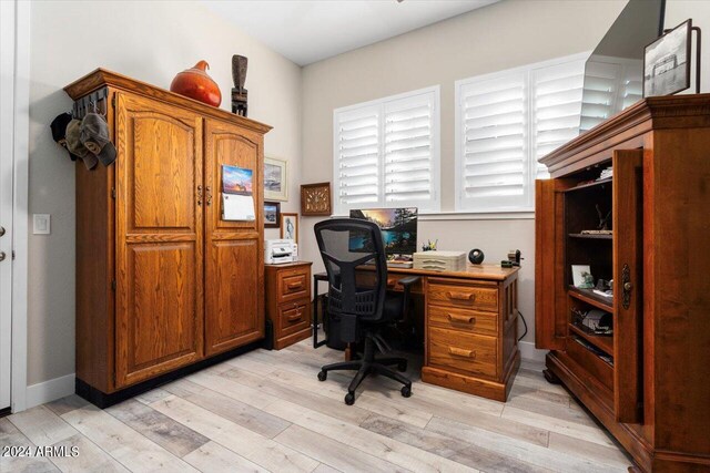 office with light wood-type flooring