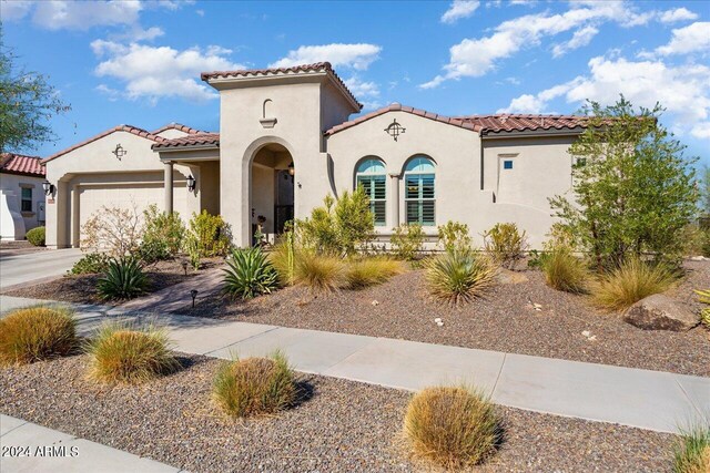 mediterranean / spanish-style home featuring a garage