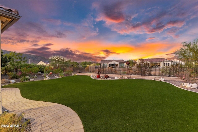 yard at dusk with a patio area