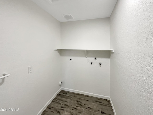 laundry room with washer hookup, dark hardwood / wood-style floors, gas dryer hookup, and electric dryer hookup