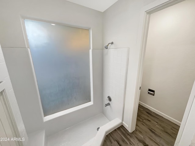 bathroom featuring wood-type flooring and walk in shower