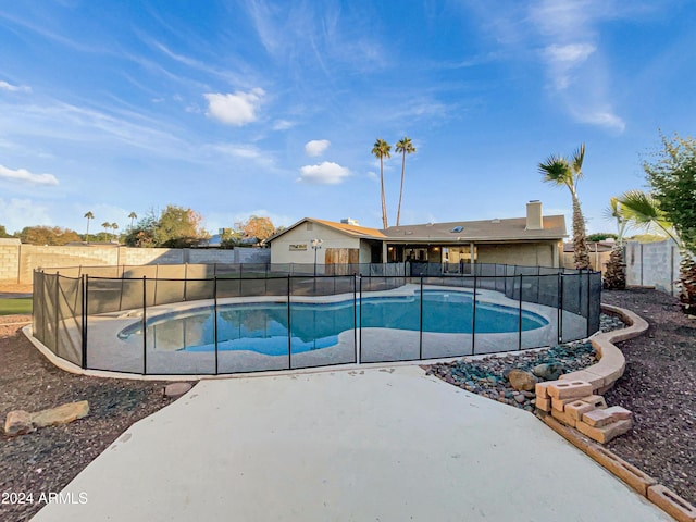 view of pool with a storage shed