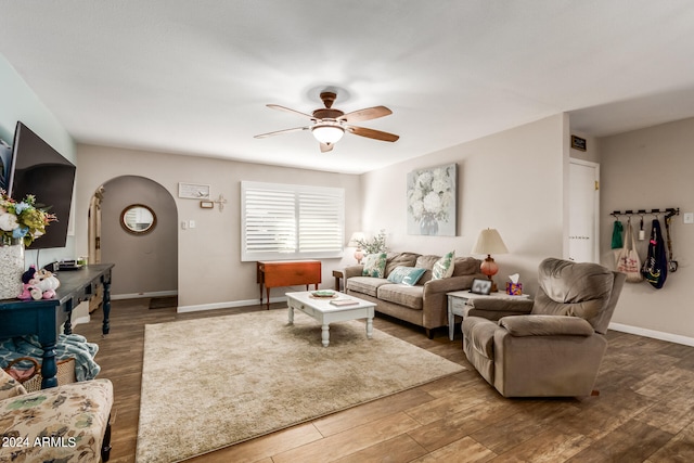 living room featuring hardwood / wood-style floors and ceiling fan