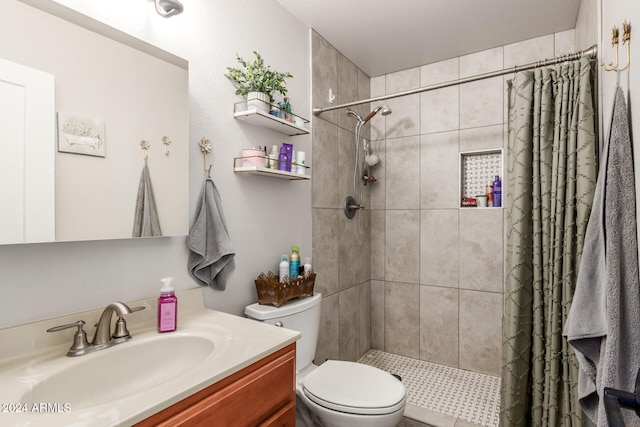 bathroom with toilet, curtained shower, and vanity