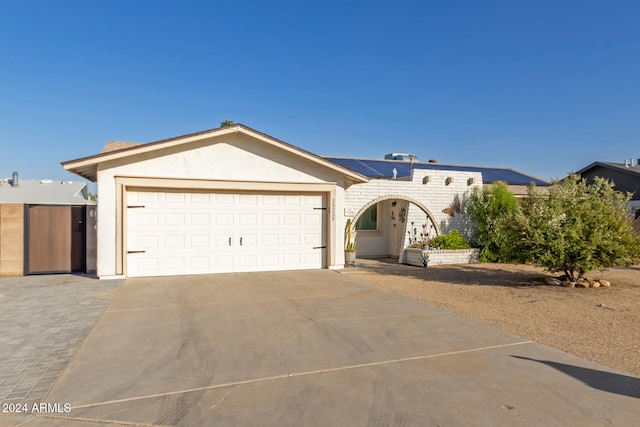 ranch-style home featuring a garage