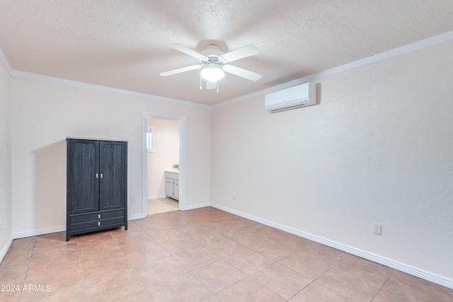 unfurnished bedroom featuring ensuite bathroom, crown molding, ceiling fan, and a wall unit AC