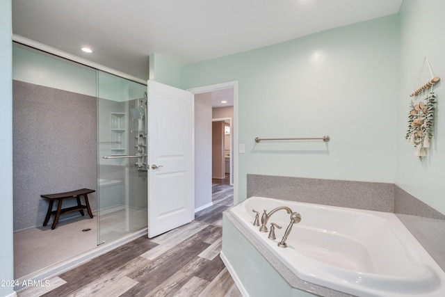 bathroom featuring separate shower and tub and hardwood / wood-style floors