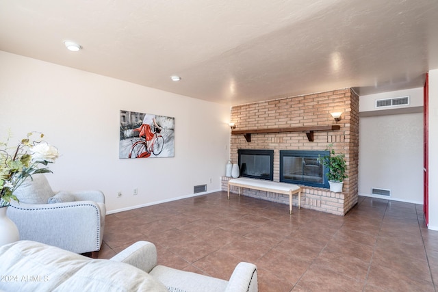 living room featuring tile patterned floors and a brick fireplace