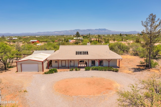 single story home featuring a porch, a mountain view, and a garage