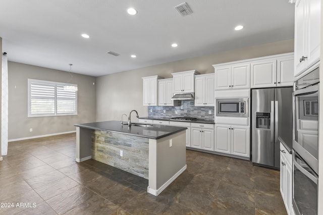 kitchen featuring dark countertops, visible vents, backsplash, and appliances with stainless steel finishes