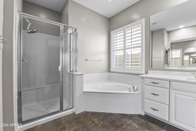 bathroom with a shower stall, plenty of natural light, vanity, and a garden tub