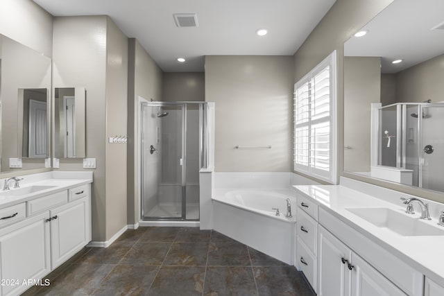 bathroom with a shower stall, a garden tub, a sink, and visible vents