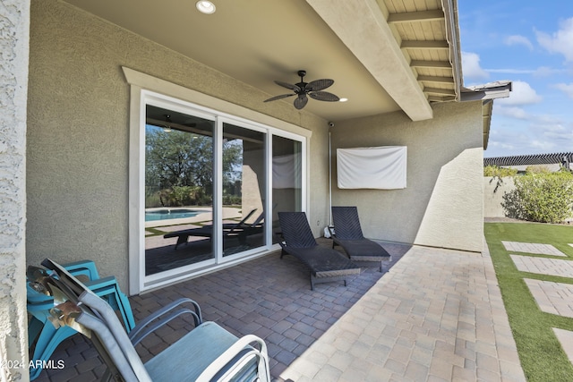 view of patio featuring fence and a ceiling fan