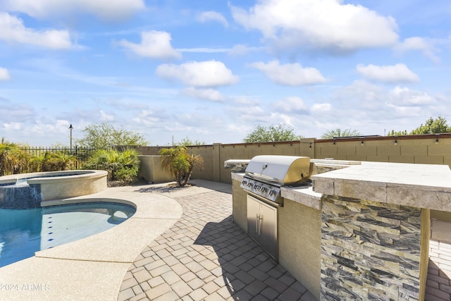view of patio with exterior kitchen, a fenced backyard, grilling area, an in ground hot tub, and a fenced in pool