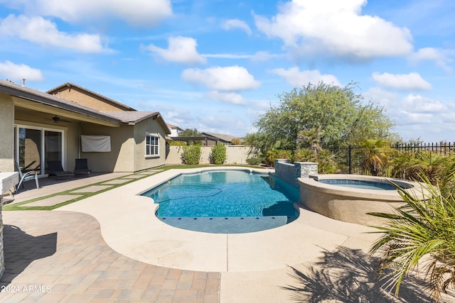 view of pool with a patio and an in ground hot tub