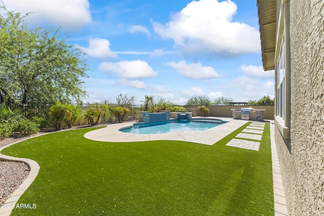 view of pool with pool water feature, a patio area, and a yard