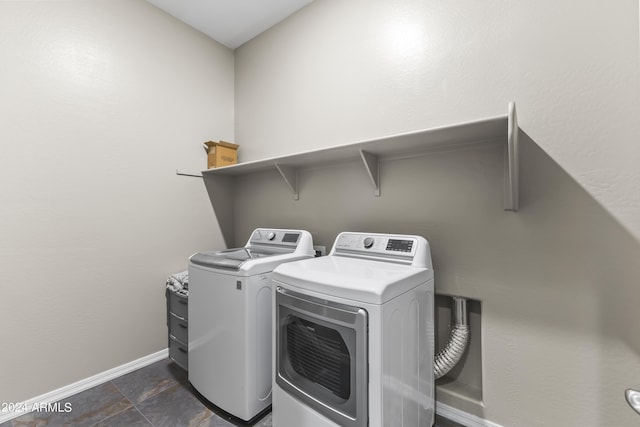 laundry room with laundry area, washing machine and clothes dryer, and baseboards