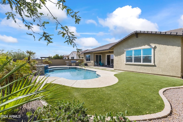 view of pool with a patio and a yard