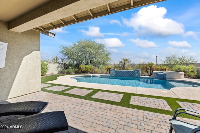 view of swimming pool with pool water feature, an in ground hot tub, and a patio area